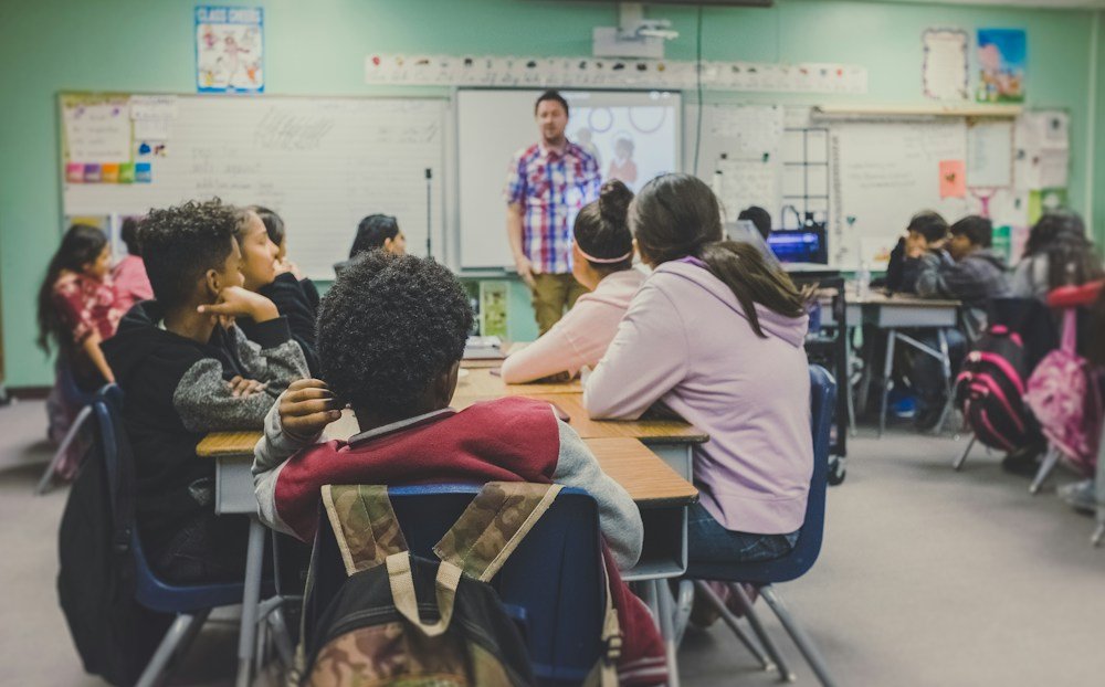 Coach and parent working collaboratively for athlete's sports growth